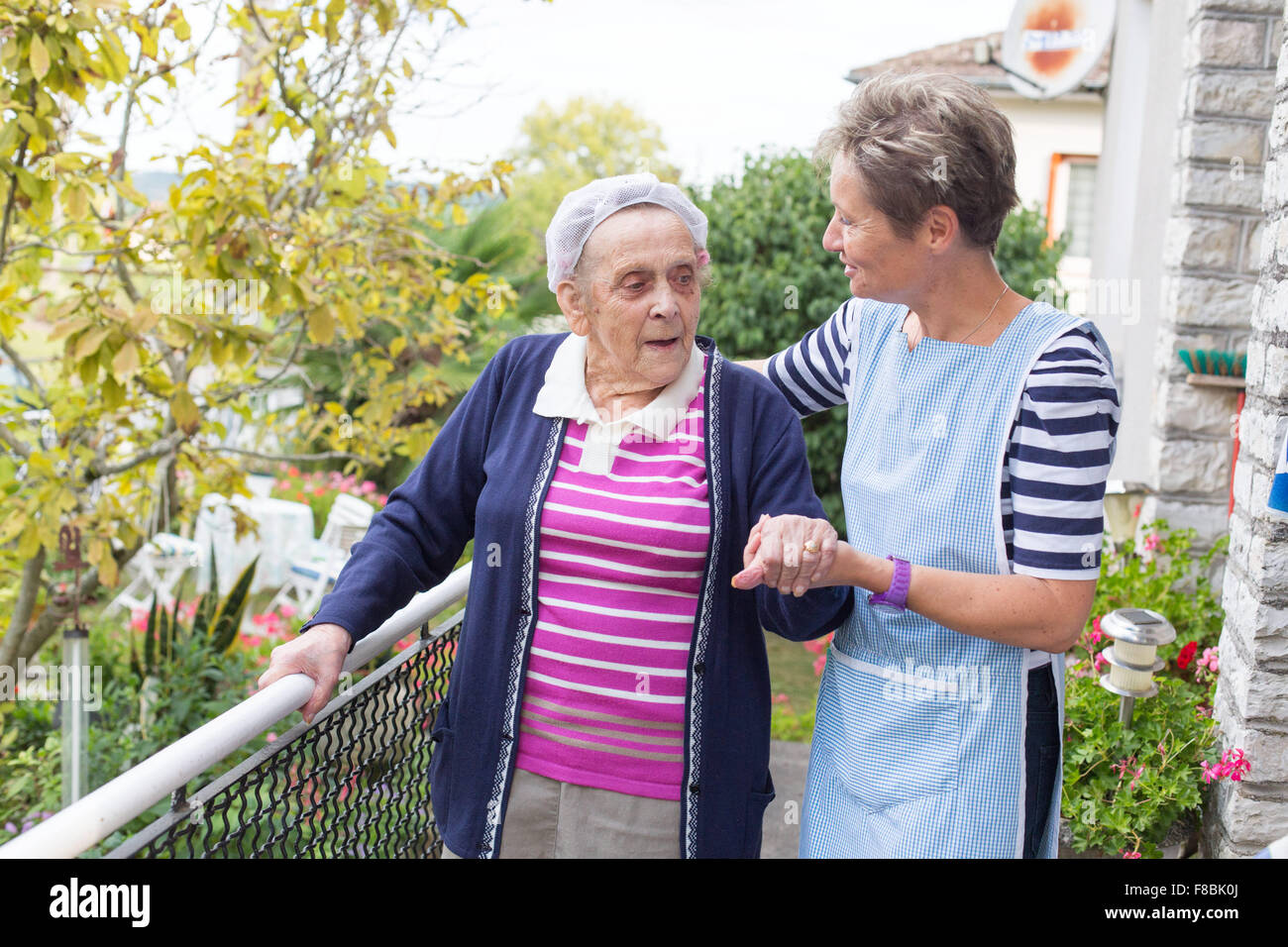 Home care aid assisting elderly woman, Dordogne, France Stock Photo Alamy