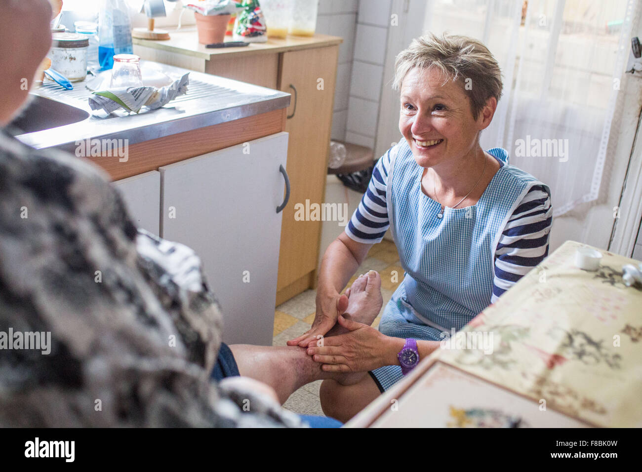 Home care aid assisting elderly woman, Dordogne, France. Stock Photo