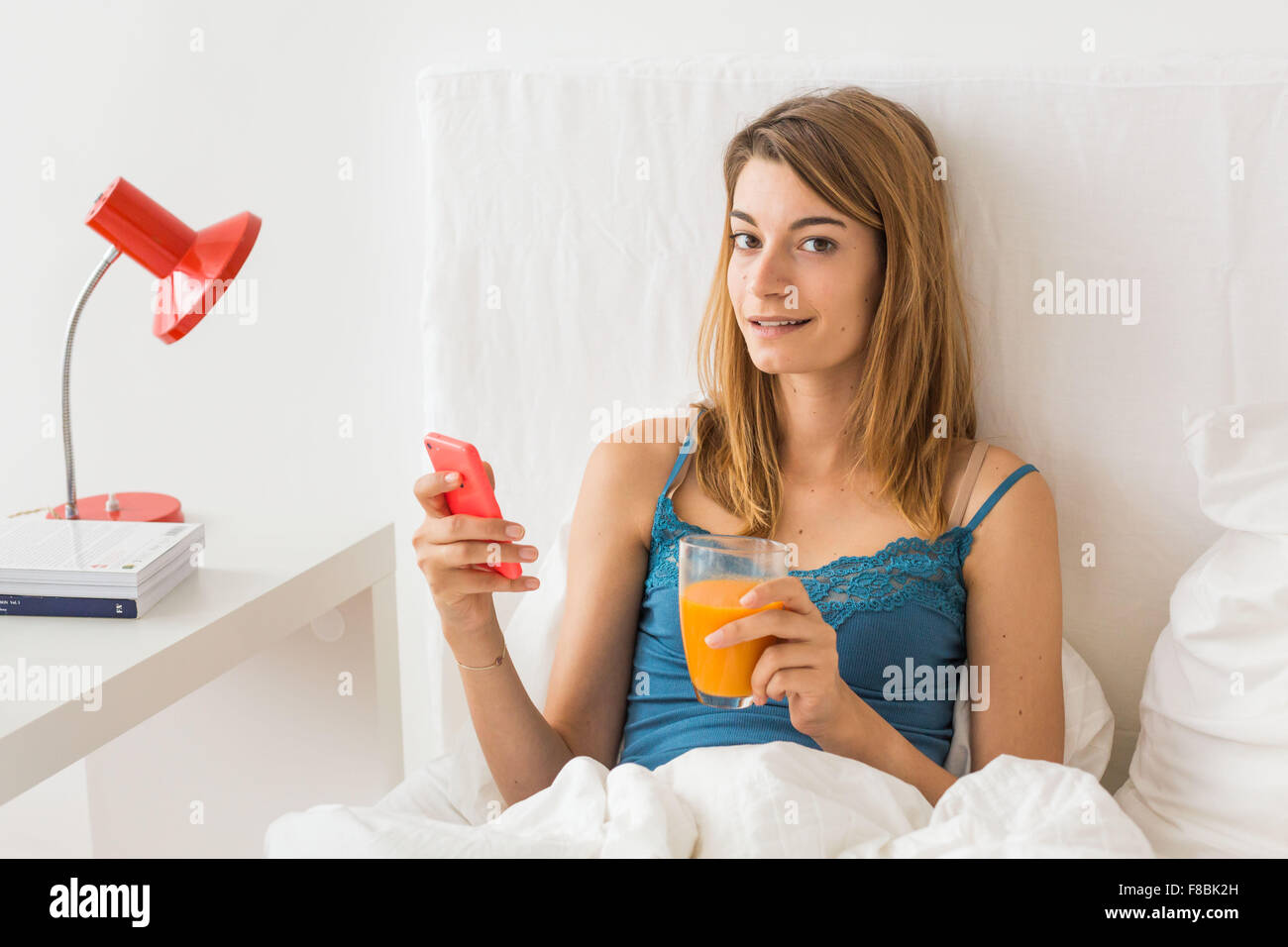 Woman using an Iphone®. Stock Photo