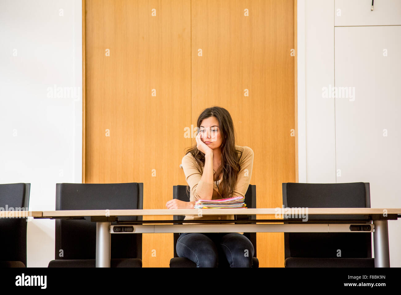 Woman alone in a conference room. Stock Photo