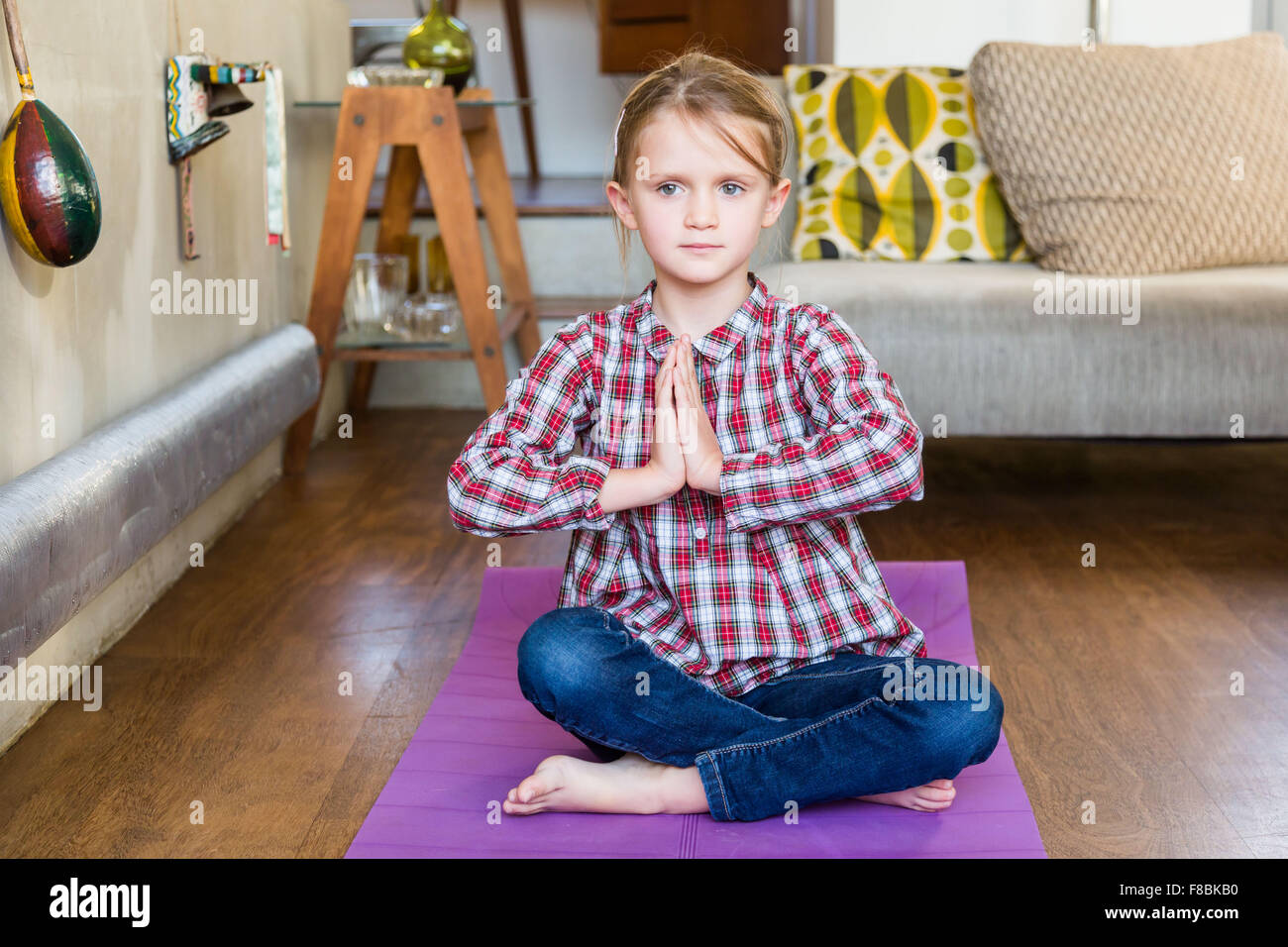 6 year-old girl practice relaxation exercises. Stock Photo