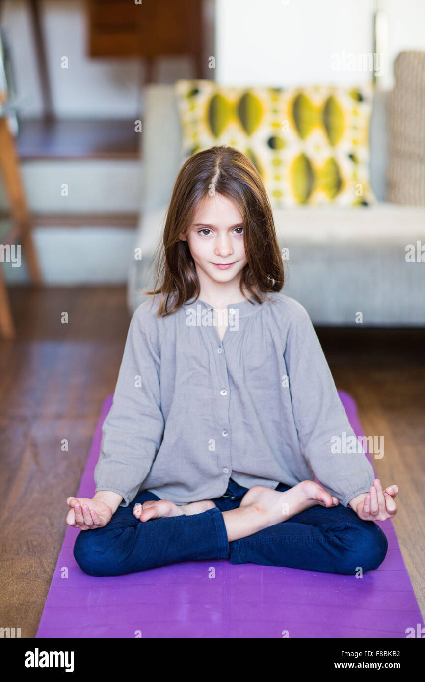 8 year-old girl practice relaxation exercises.. Stock Photo