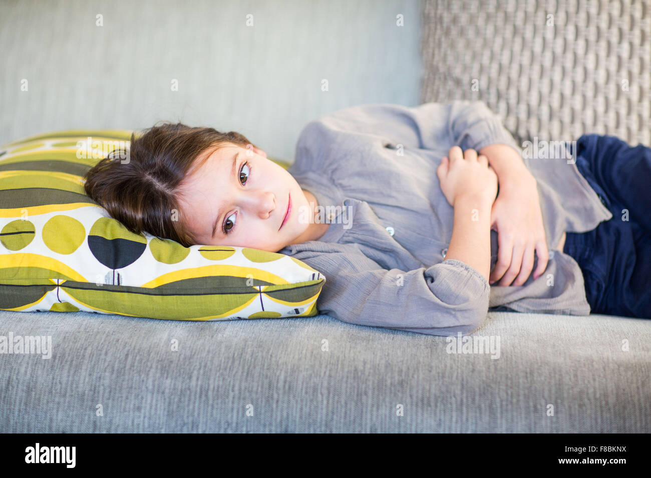 8 year-old child suffering from bellyache. Stock Photo