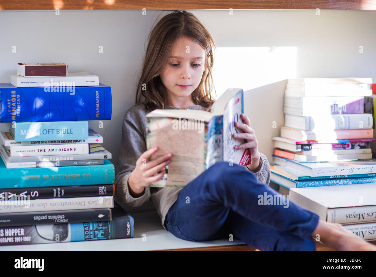 8 year-old girl reading. Stock Photo