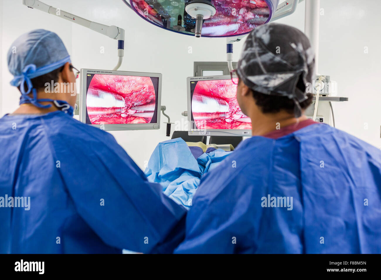 Surgical team performing prostatectomy (prostate ablation) under coeliosurgery. Stock Photo