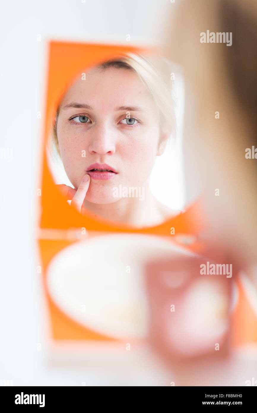 Young woman with finger on lips. Stock Photo