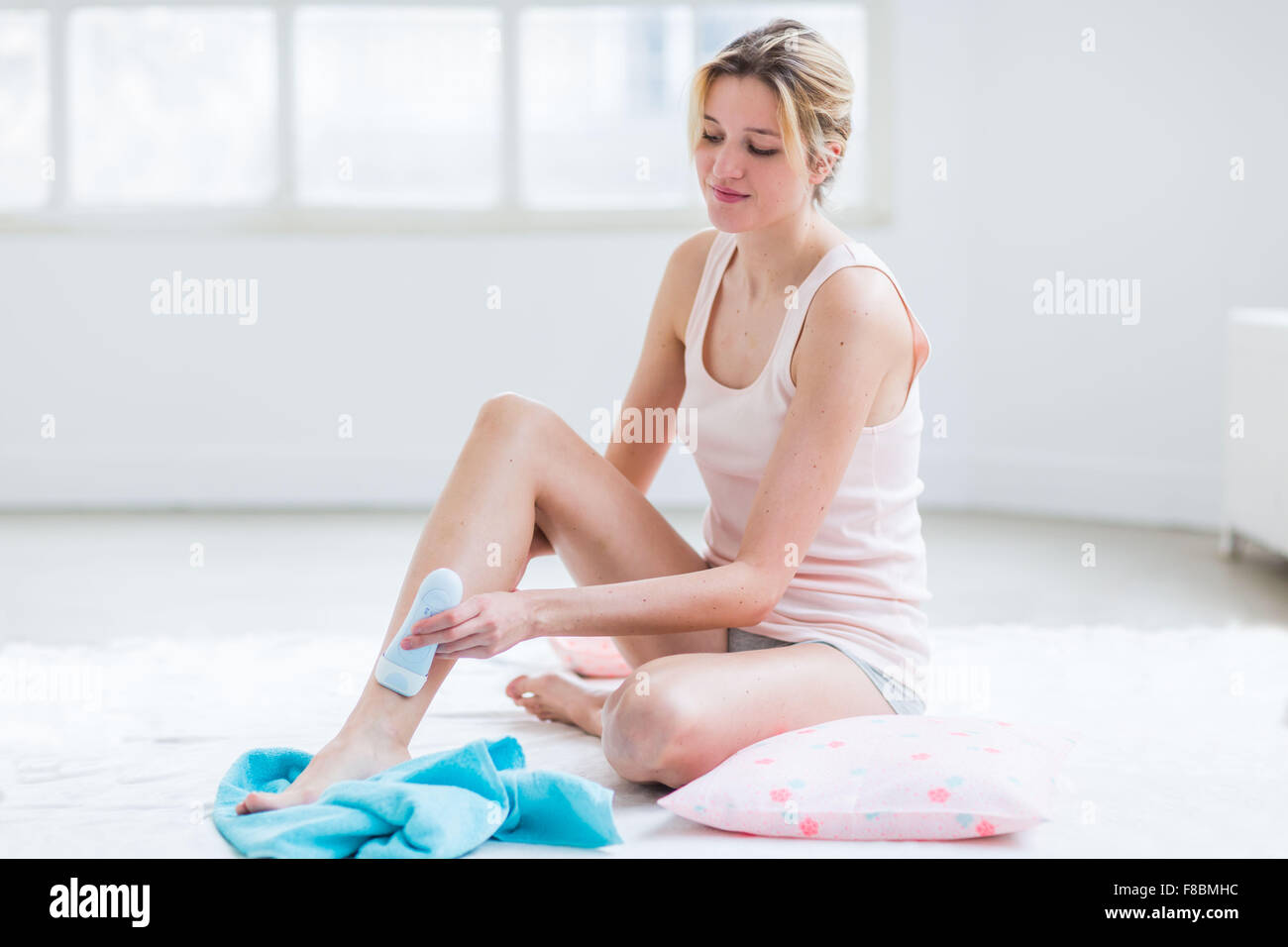 Woman shaving her legs. Stock Photo