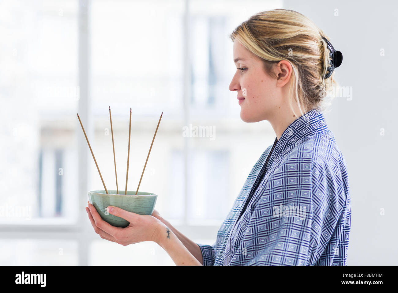 Woman burning incense. Stock Photo