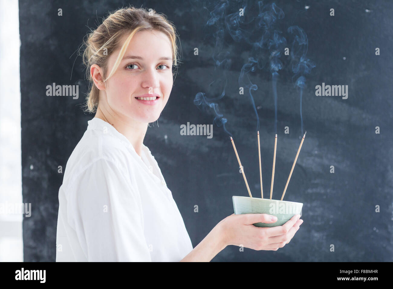 Woman burning incense Stock Photo Alamy