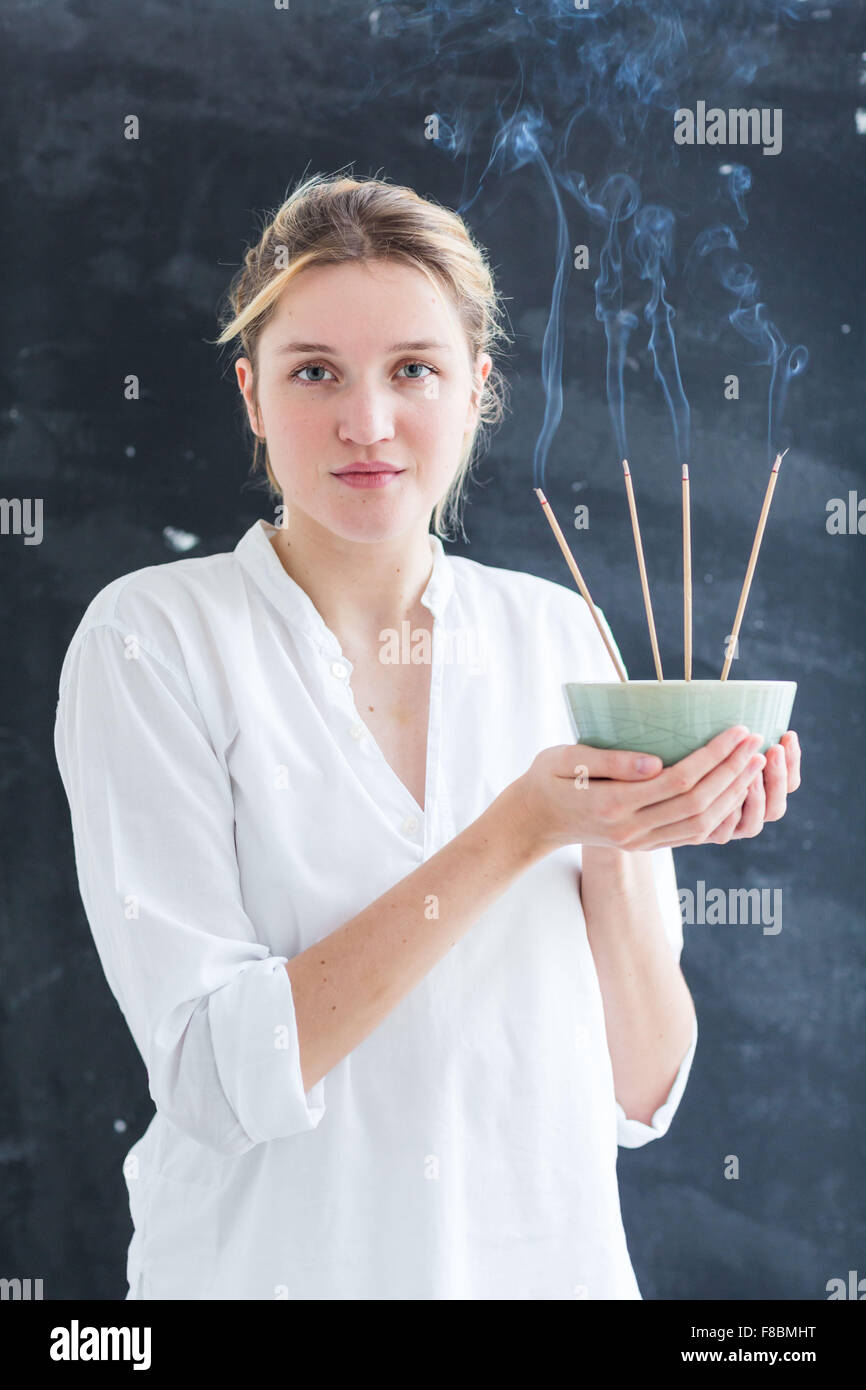 Woman burning incense Stock Photo Alamy