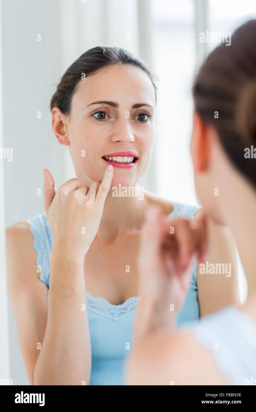 Woman with finger on lips. Stock Photo