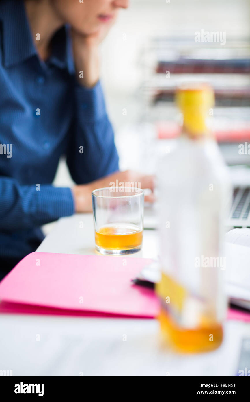 Office worker drinking alcool. Stock Photo