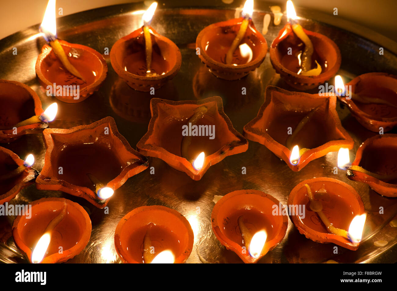Lamps lit for Diwali Puja, an important Hindu festival, which symbolizes victory of good over evil. Stock Photo