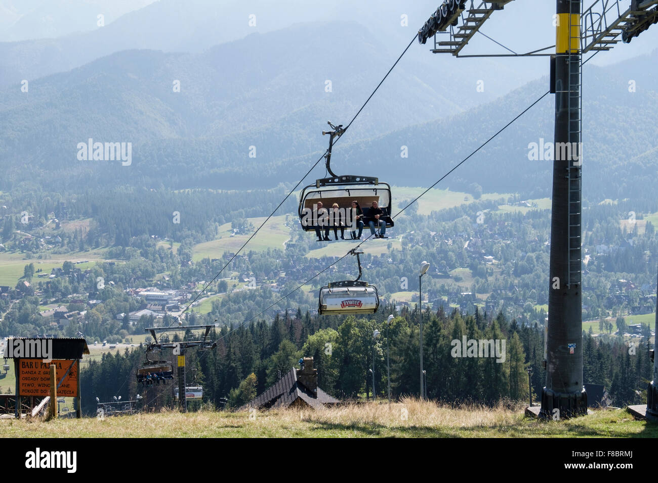 People riding on Butorowy Wierch Chairlift up to Gubałowka Mountain, Zakopane, Tatra County, Poland Stock Photo