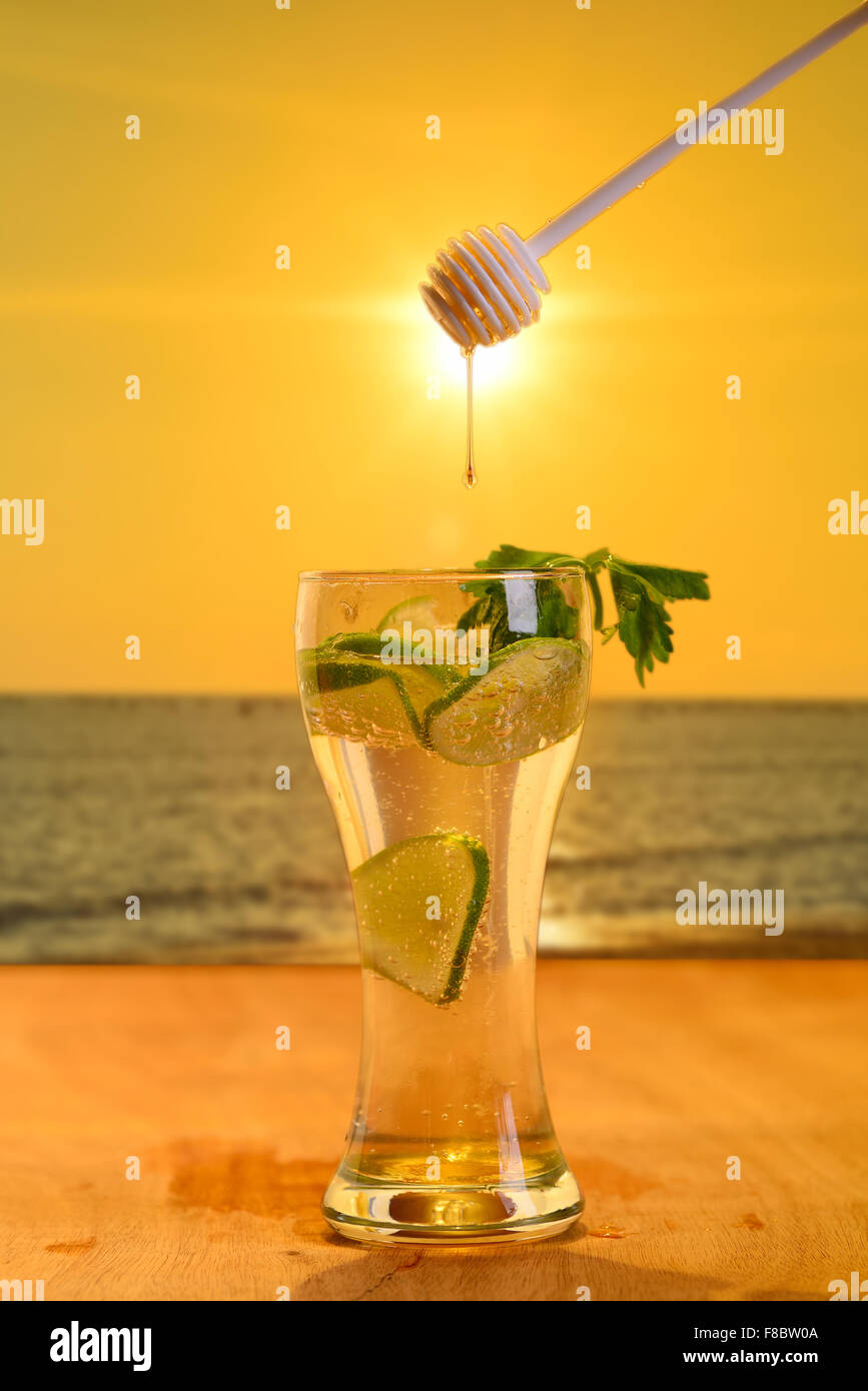 Mix lemon juice with honey background evening sky and sunset Stock