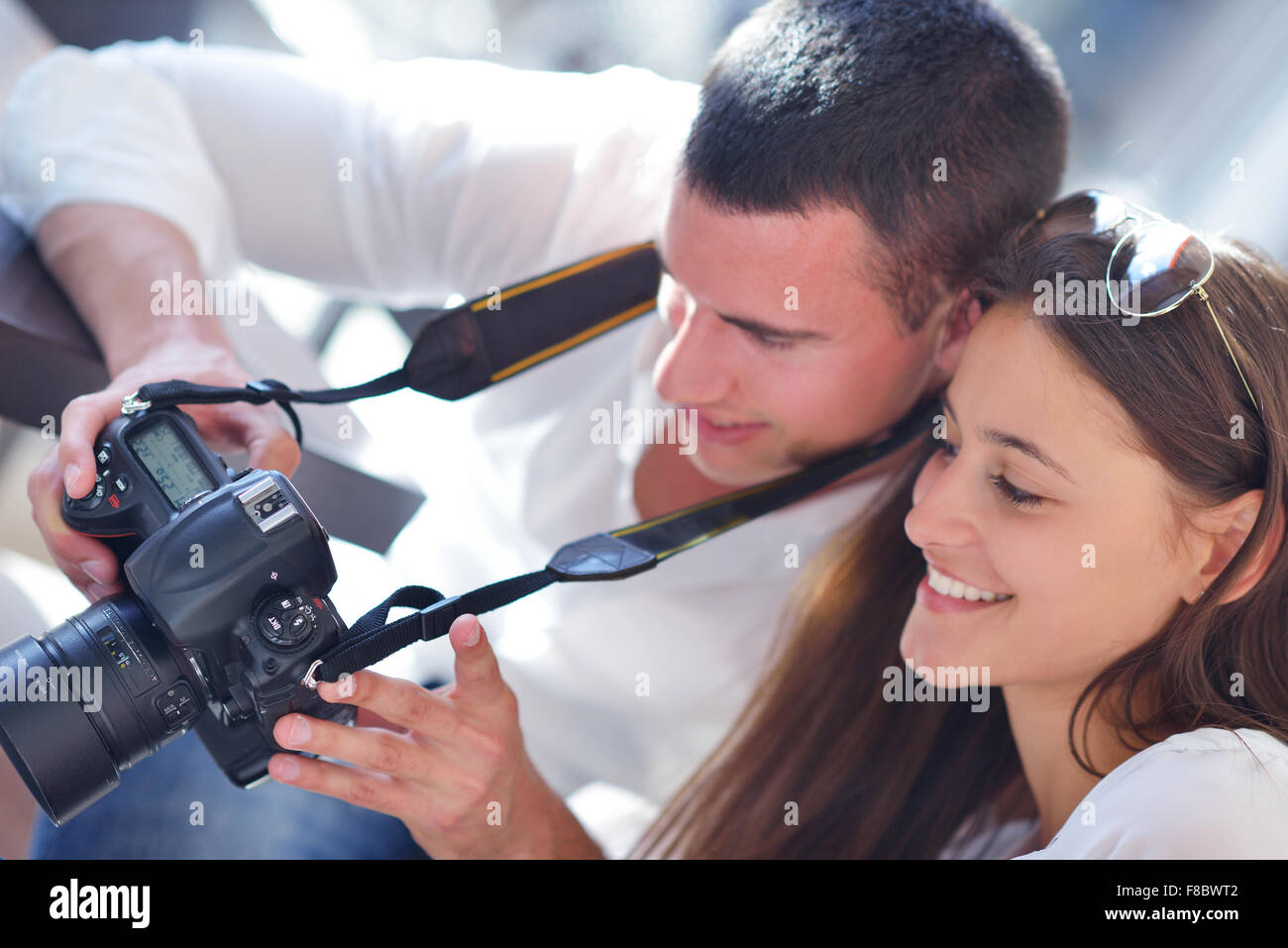 happy young romantic couple looking photos on camera Stock Photo - Alamy