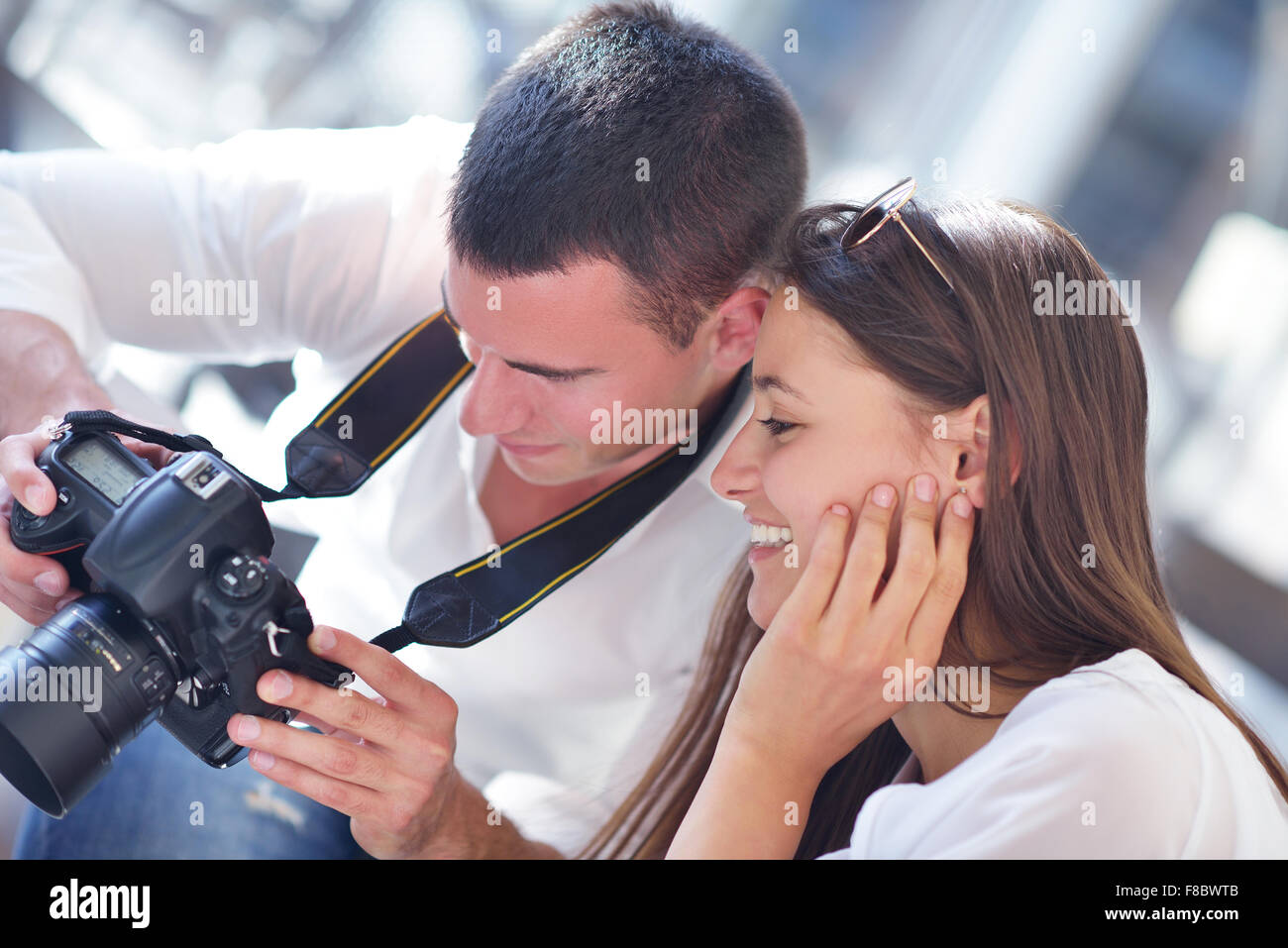 happy young romantic couple looking photos on camera Stock Photo - Alamy