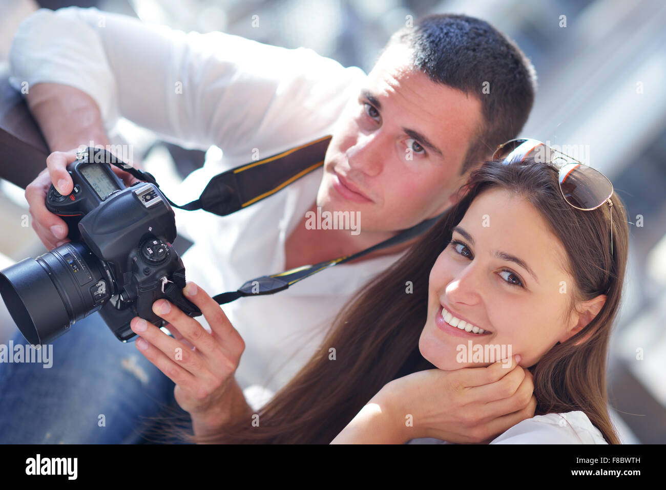 happy young romantic couple looking photos on camera Stock Photo - Alamy