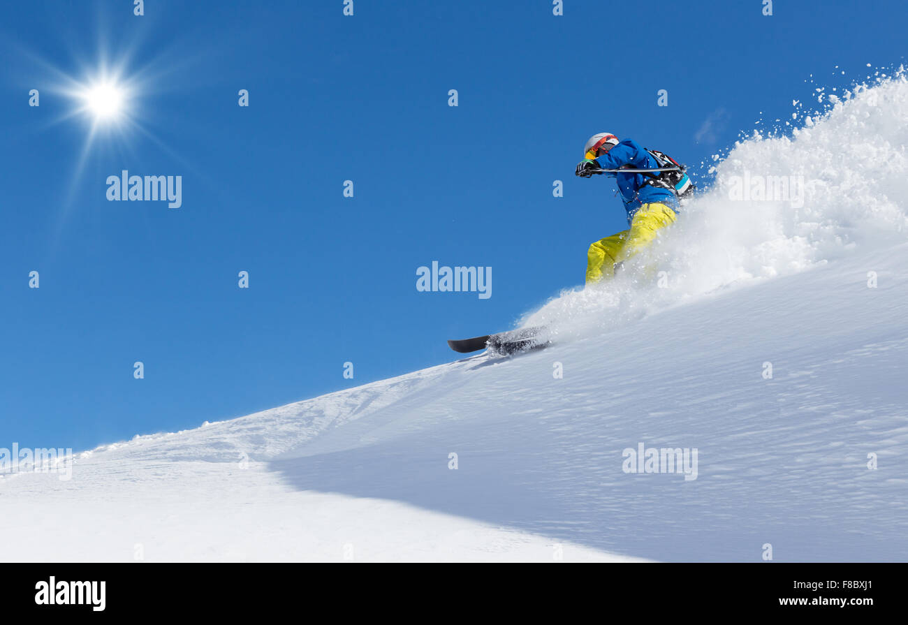 Man skier running downhill Stock Photo