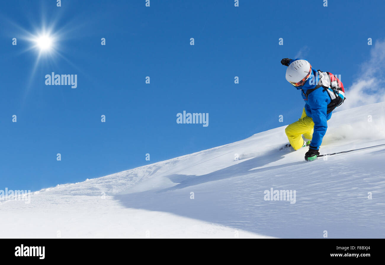 Man skier running downhill Stock Photo