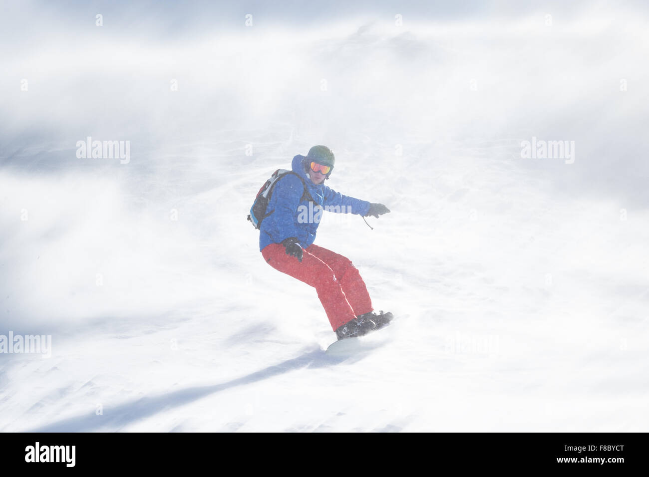 Snowboarder running down on piste Stock Photo