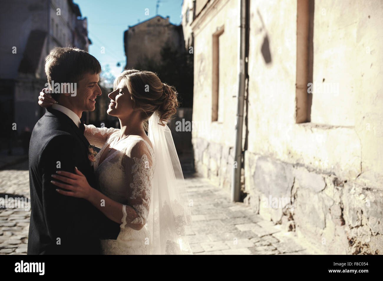 bride and groom posing on the streets Stock Photo - Alamy