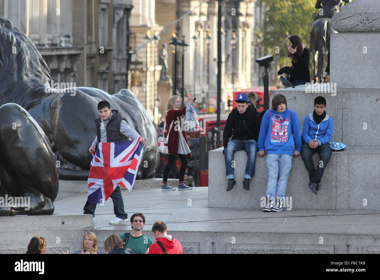 Young male holds union jack flag in trafalgar square london Stock Photo