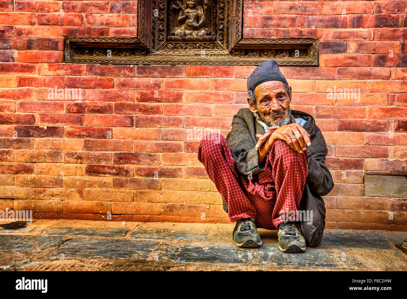 Old beggar in the street of Kathmandu Stock Photo