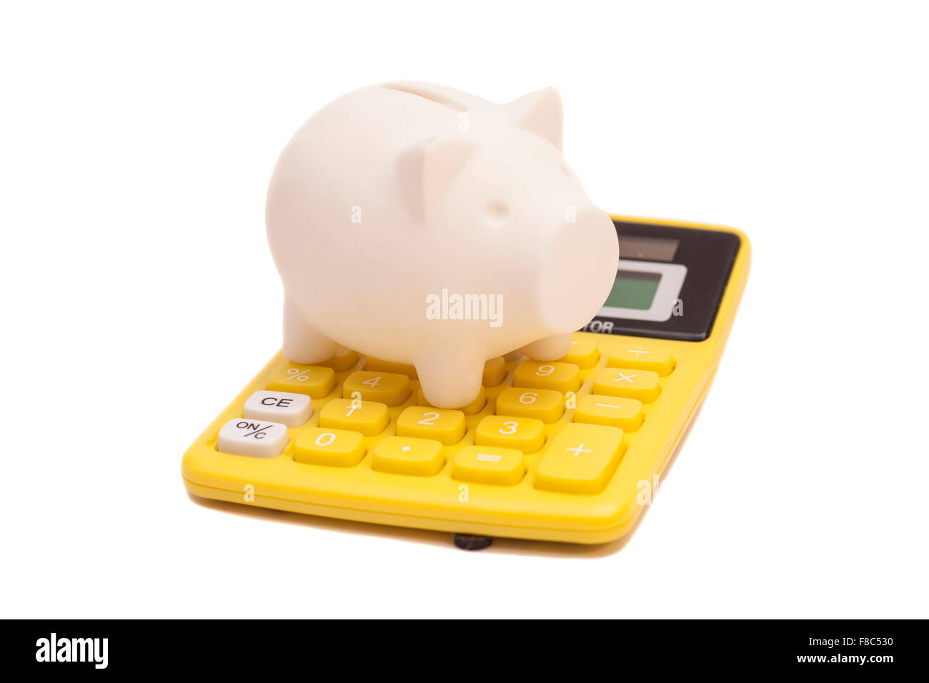 Piggy bank and callculator isolated on white background Stock Photo - Alamy