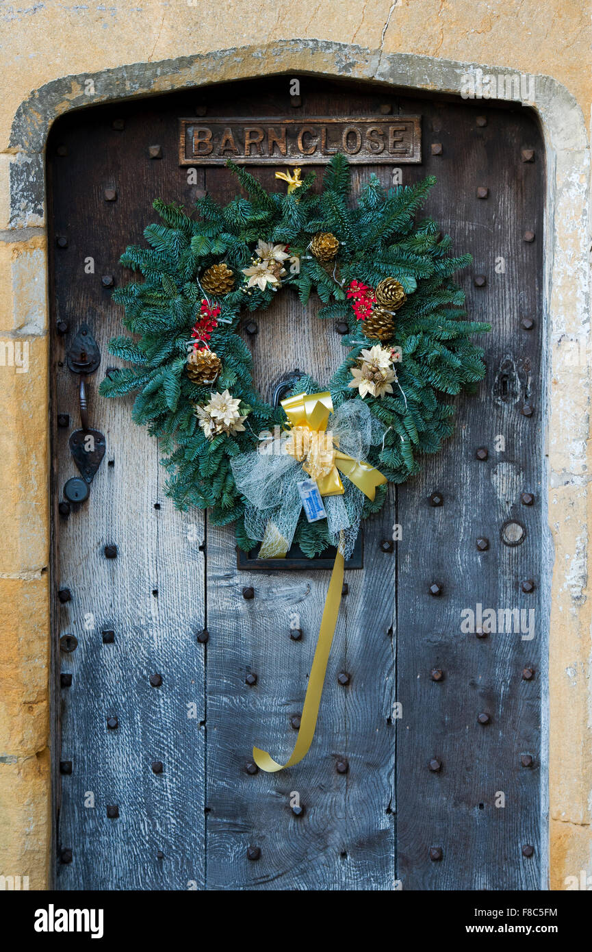 Christmas wreath on an old oak wooden door in Broadway, Cotswolds, England Stock Photo