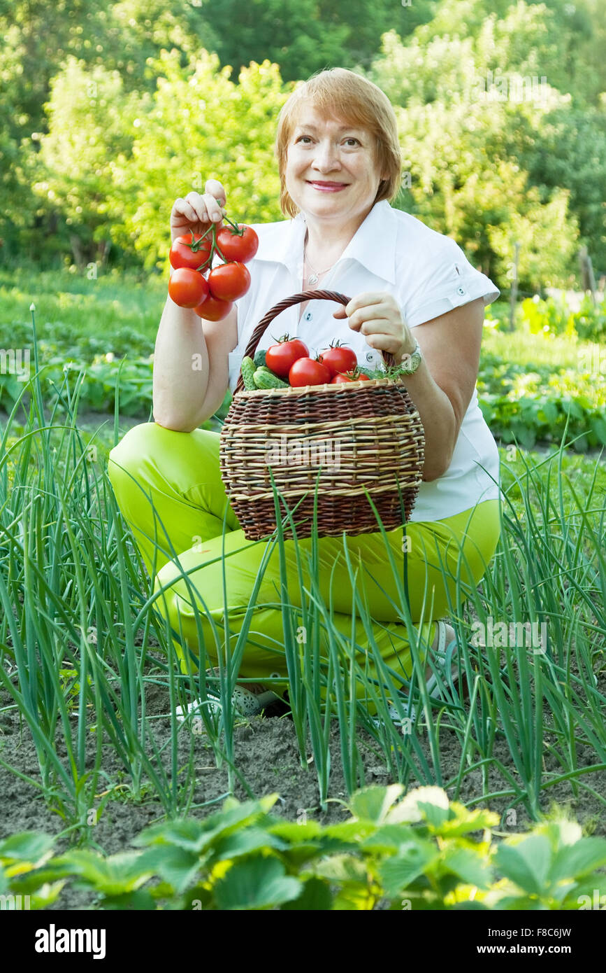 Happy mature woman with vegetables harvest Stock Photo - Alamy