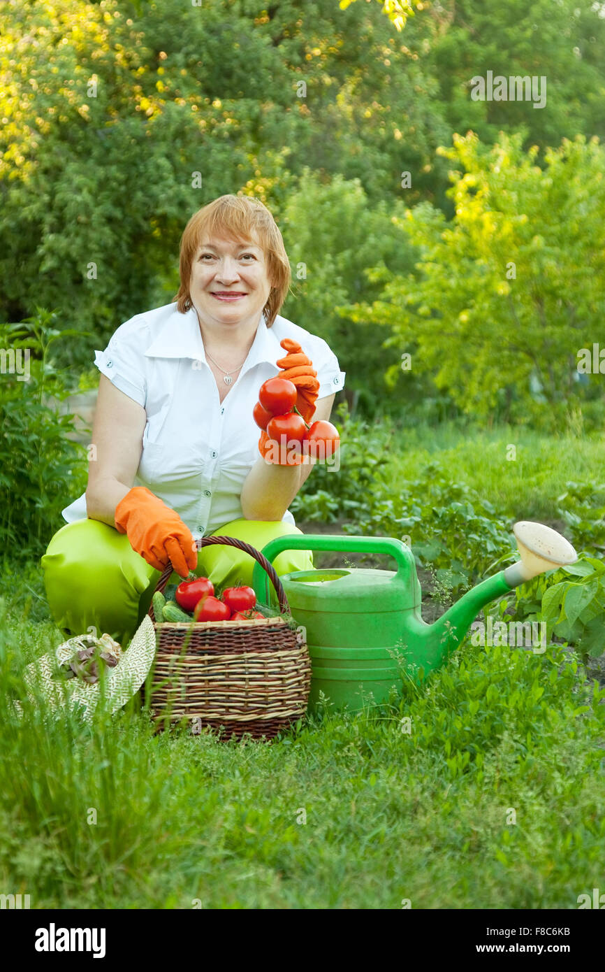 Happy mature woman with vegetables harvest Stock Photo - Alamy