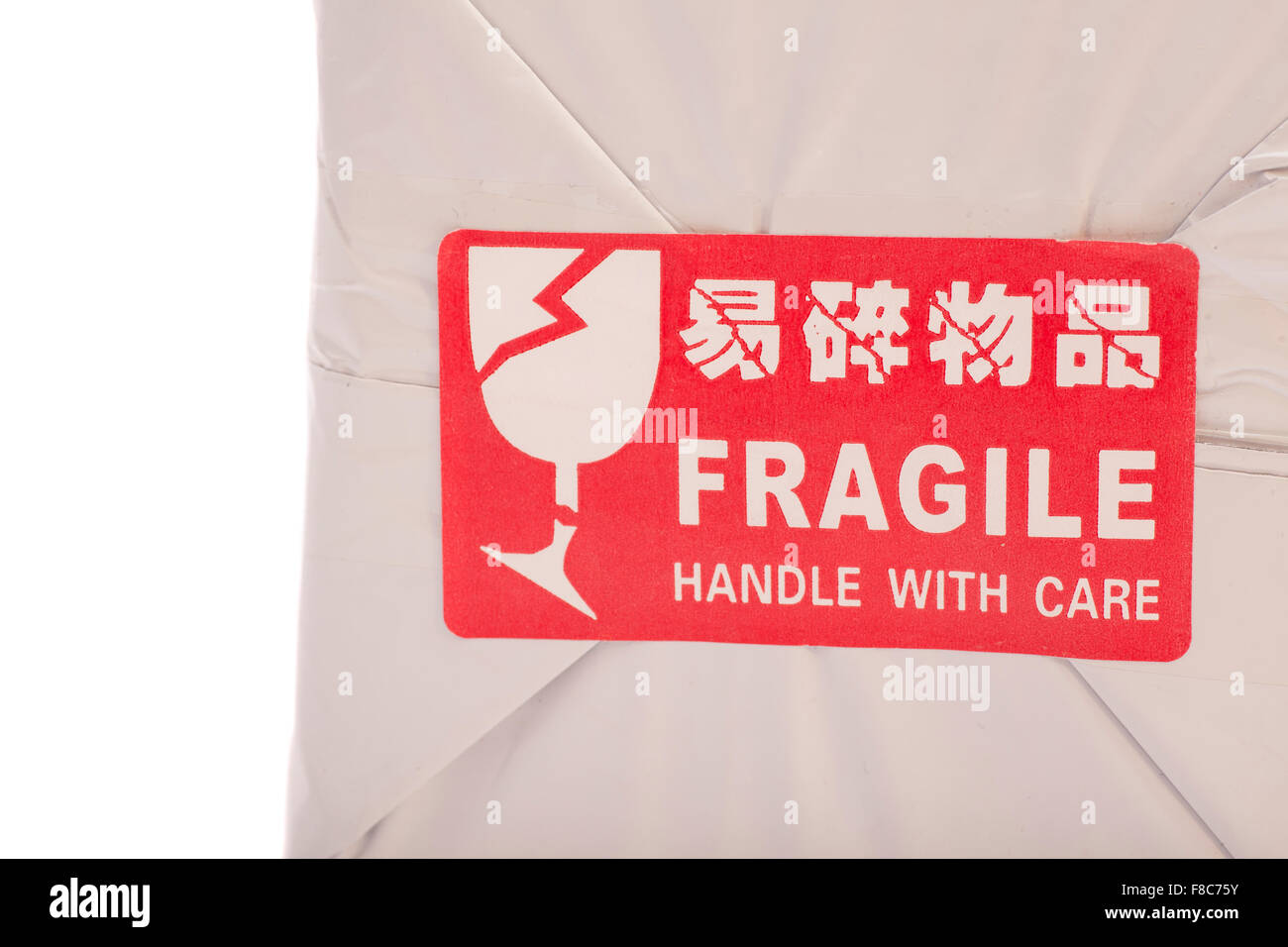 A red 'Fragile' sticker on  box Stock Photo