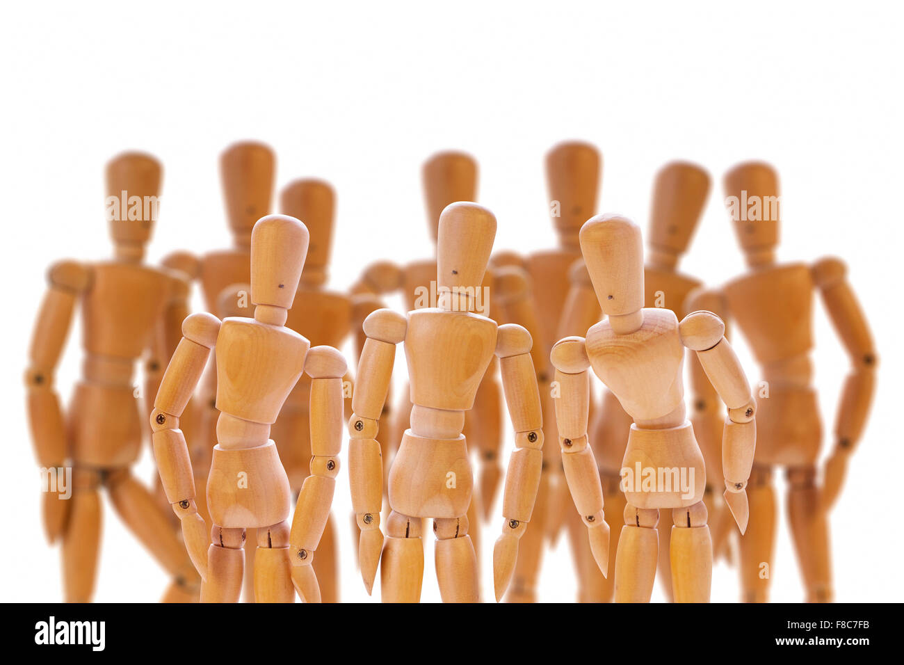 Scene with group of wooden dummies isolated on white. Stock Photo