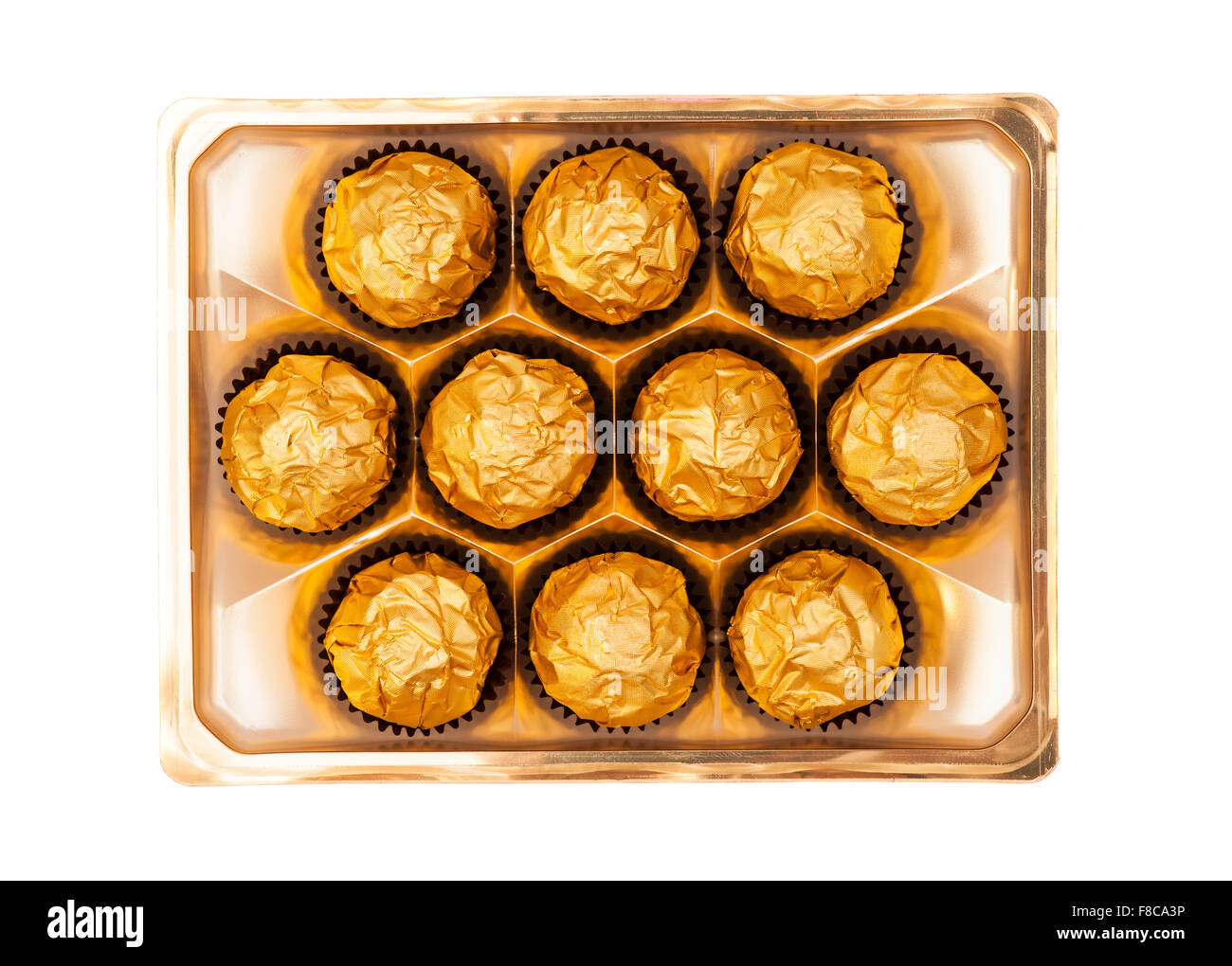 Chocolate balls with almond in gold foil paper on white Stock Photo Alamy
