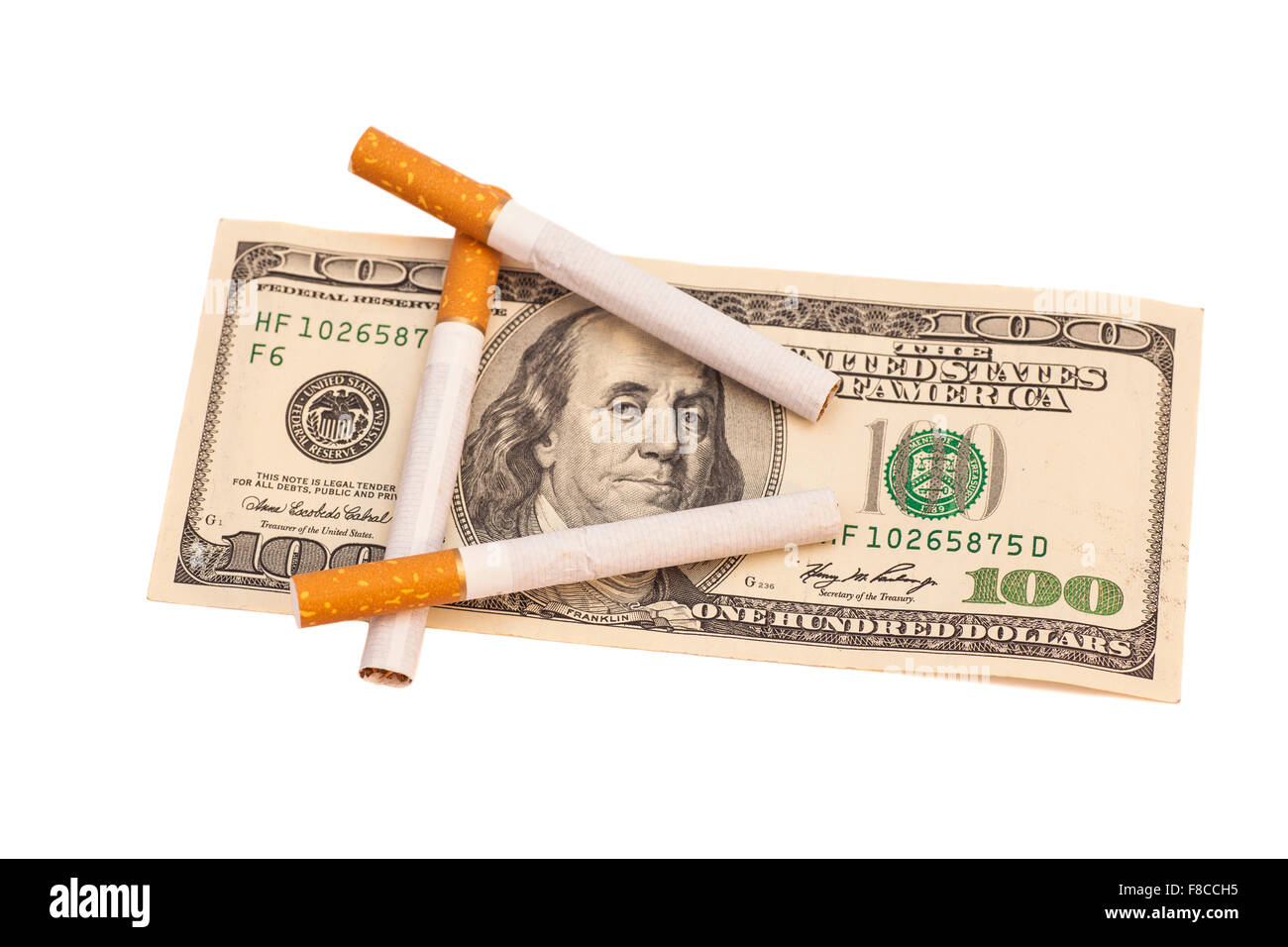 Cigarettes on one hundred dollar bill on white background Stock Photo