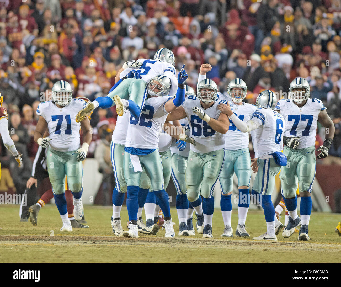 Dallas Cowboys kicker Dan Bailey (5) is carried by tight end Jason
