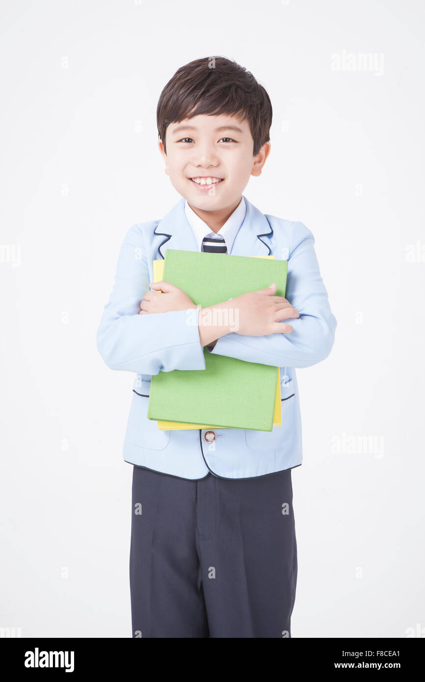 Boy holding school books hi-res stock photography and images - Alamy