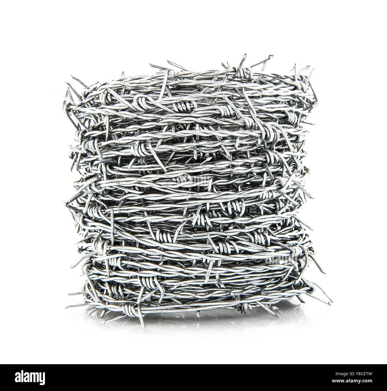 Coil of Barbed wire isolated on white background Stock Photo