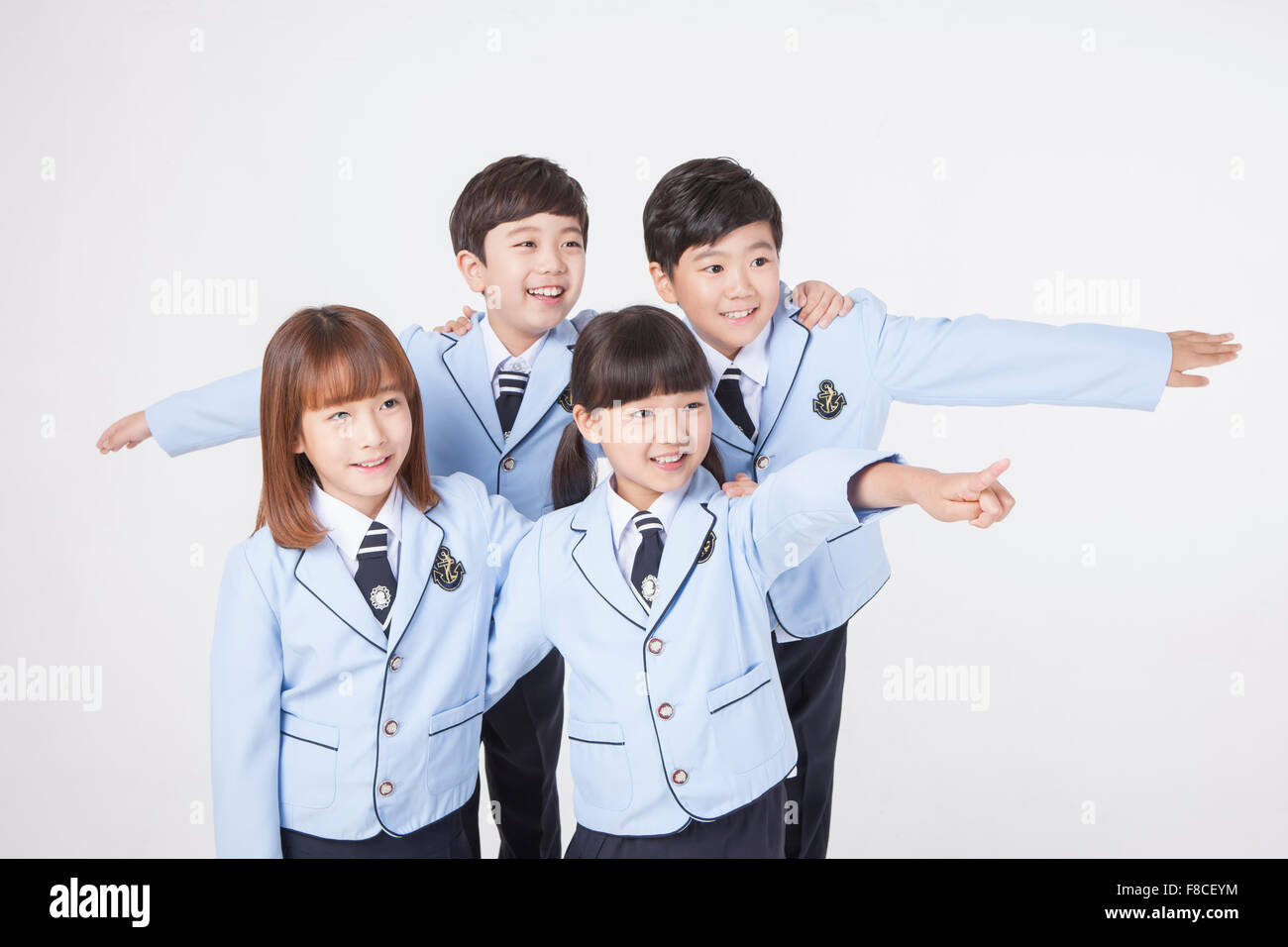 Two elementary school boys in school uniforms putting their arms around