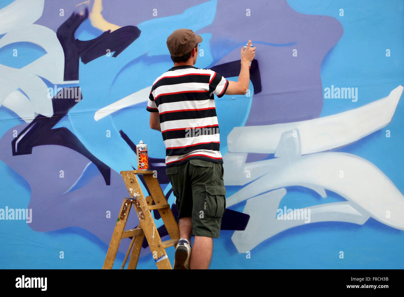 Painter in action on the wall of Berlin Stock Photo Alamy
