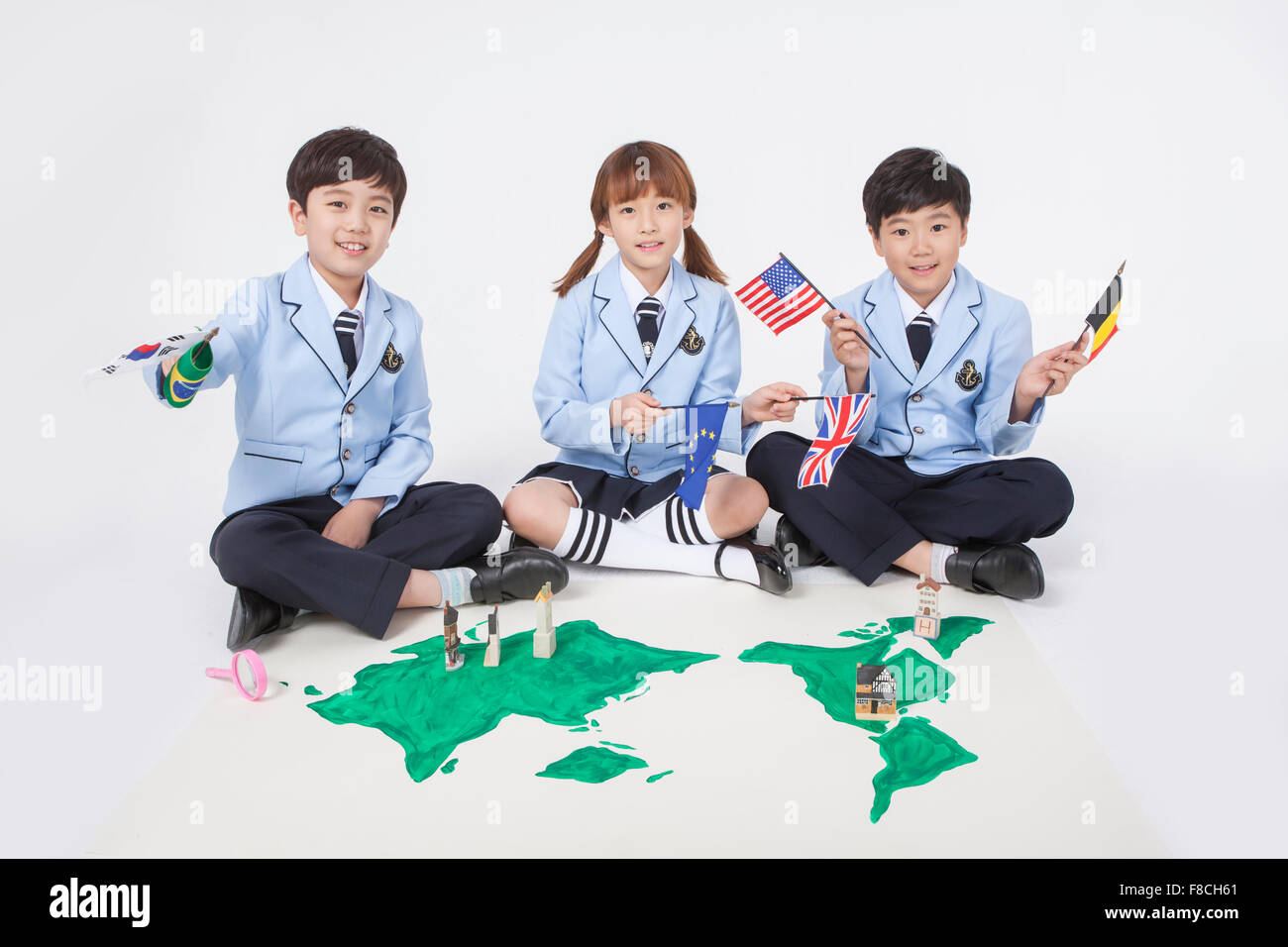 Uniform Map Three elementary school students in school uniforms sitting down and ...