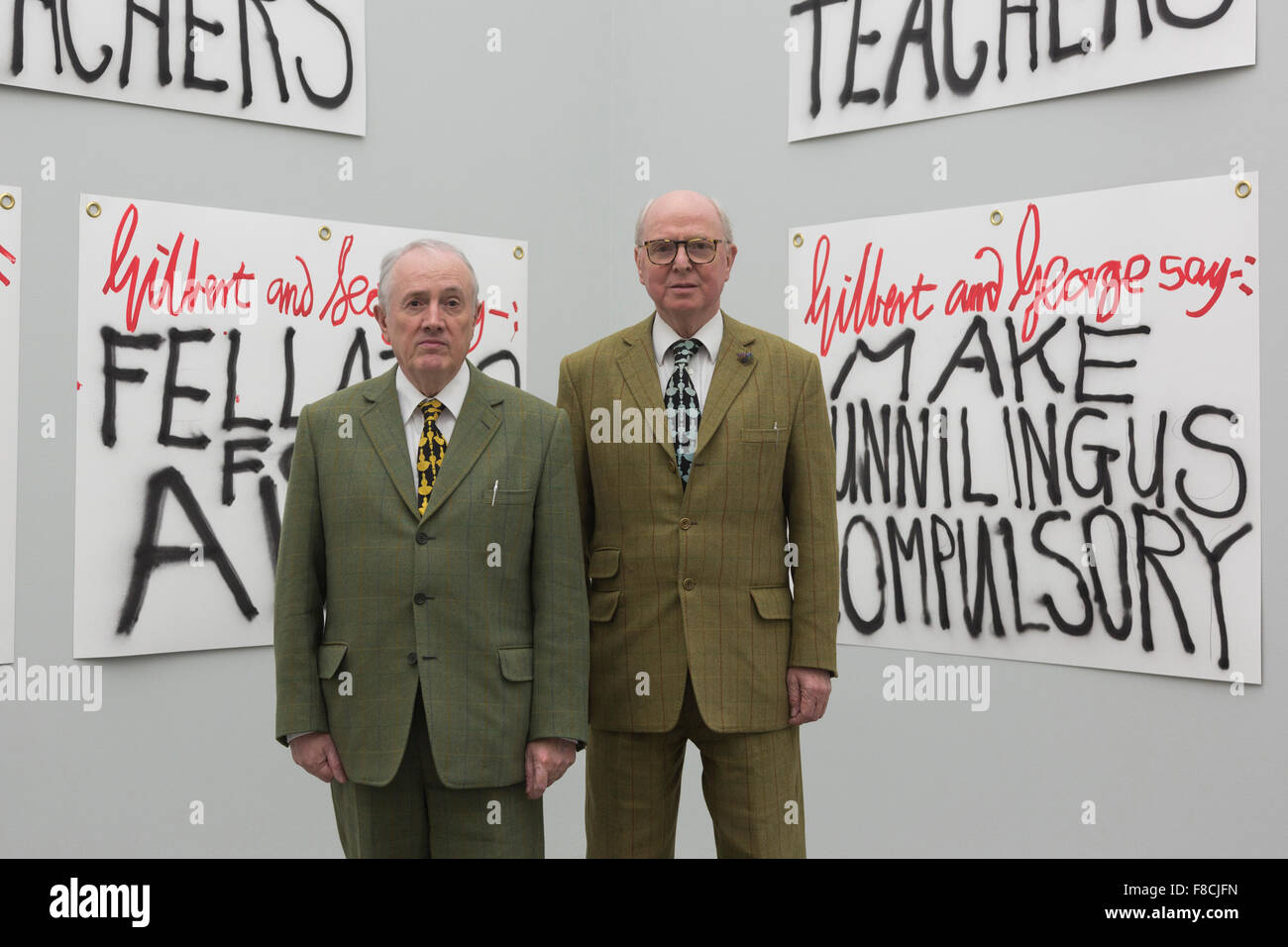 London, UK. 8 December 2015. Pictured: L-R: Gilbert & George in front of their artworks The Banners. Artists Gilbert & George launch their latest publication The Banners, as well as 10 poster designs, made to coincide with their exhibition at White Cube Bermondsey. The exhibition The Banners runs from 25 November 2015 to 24 January 2016. Stock Photo