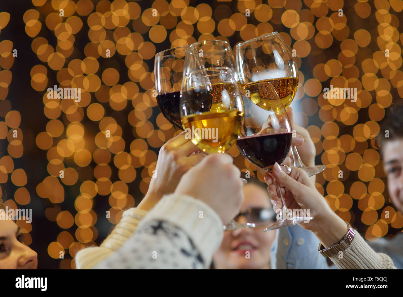 Celebration. Hands holding the glasses of champagne and wine making a ...