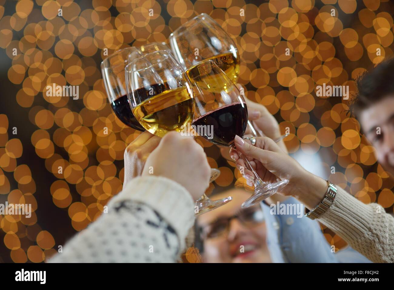 Celebration. Hands holding the glasses of champagne and wine making a ...