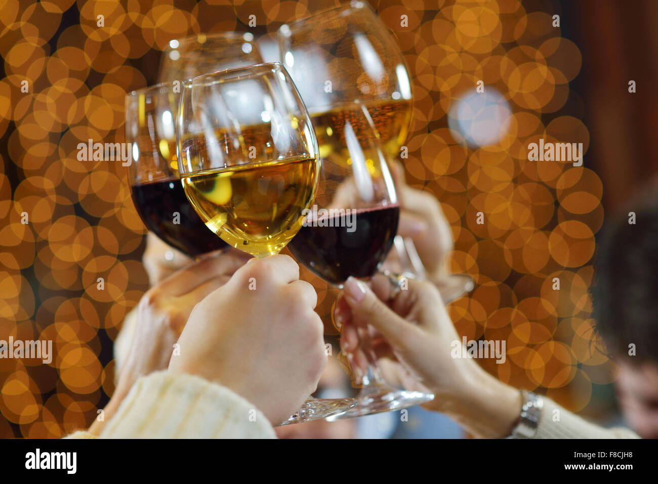 Celebration. Hands holding the glasses of champagne and wine making a ...