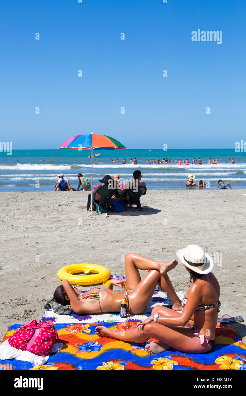 Girls sun bathing on the beach Stock Photo