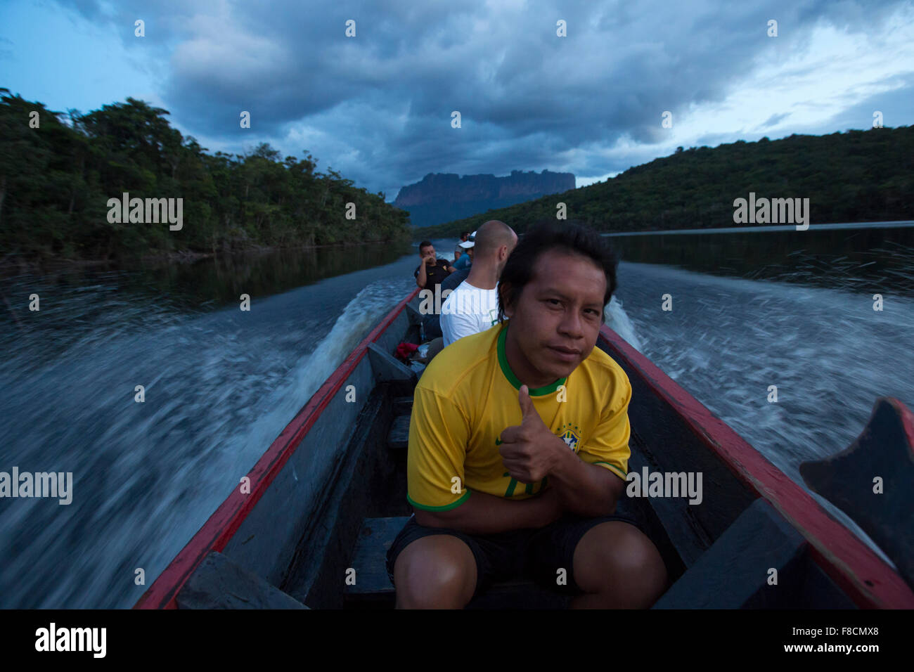 local guide sitting in a boat Canaima National Park Stock Photo