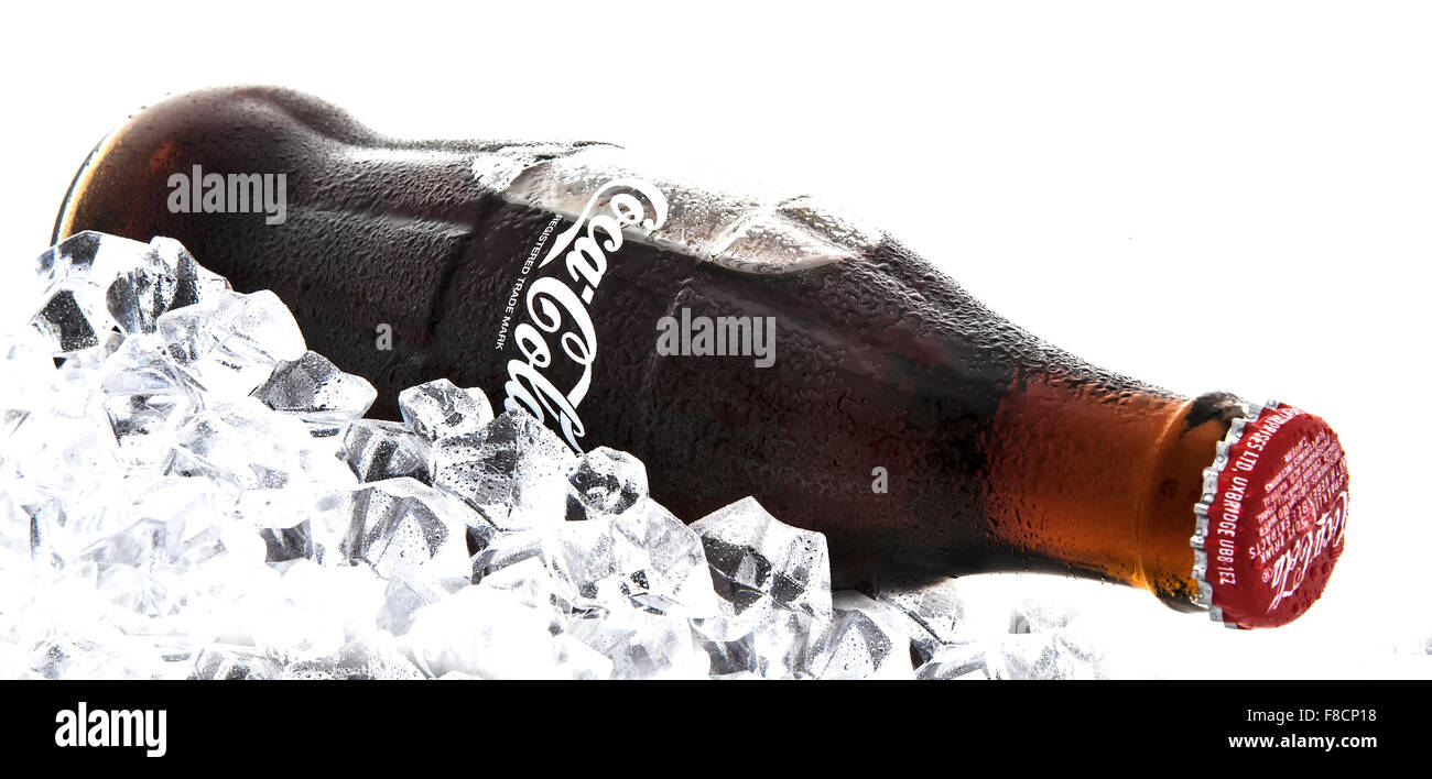 Classic bottle of Coca-Cola on a bed of ice over a white background Stock Photo