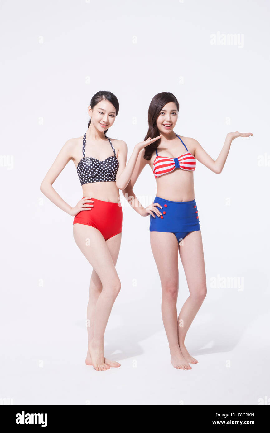 Two Girls Wearing Swimsuits Standing In Doorway Portrait Stock